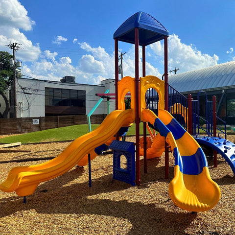 Kids playing on a playground at a park.