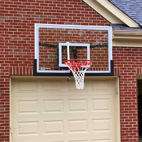 Parents and kids playing basketball outside.